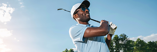 A golfer finishing his swing