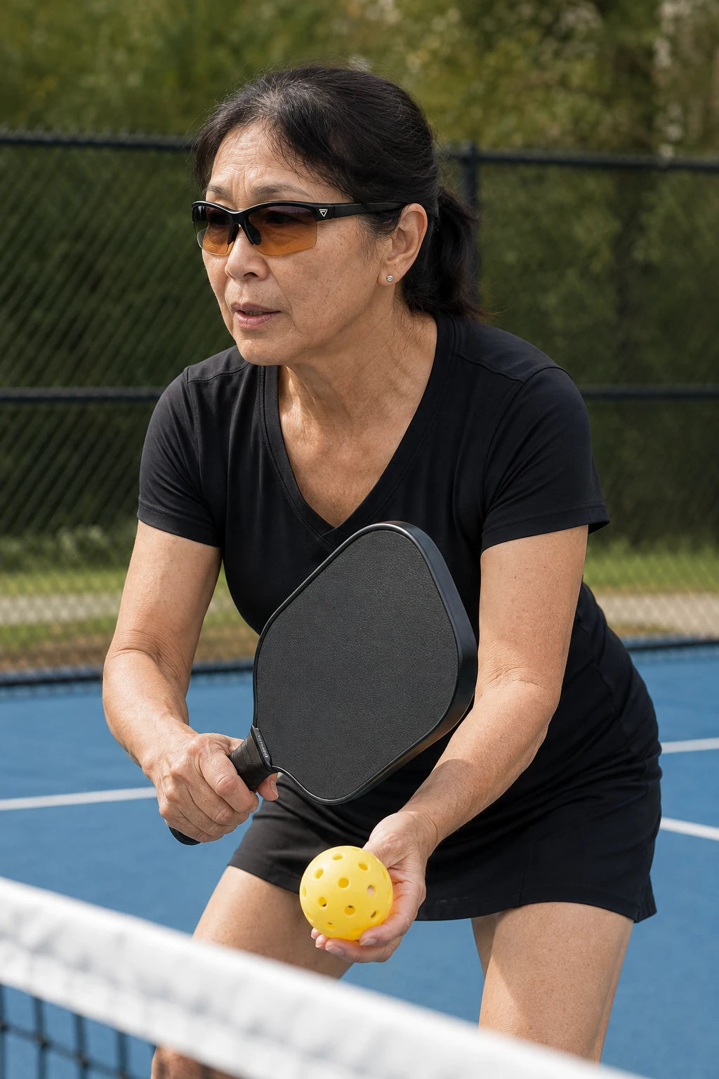 Pickleball activity featuring PeakVision GX5 sunglasses with silver temple emblem